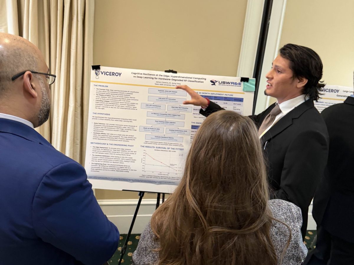 Adrian Cisneros presenting his research poster to visitors